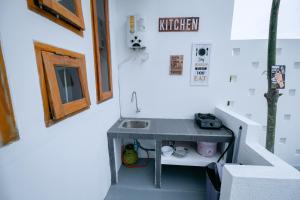 a tiny house with a sink in the stairs at Calda Homestay Syariah in Bandung +23 photos
