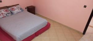 a small bedroom with a bed and a dresser at Leila in Agadir