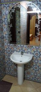 a bathroom with a sink and a mirror at Leila in Agadir