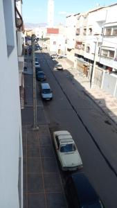 a street with cars parked on the side of a building at Leila in Agadir