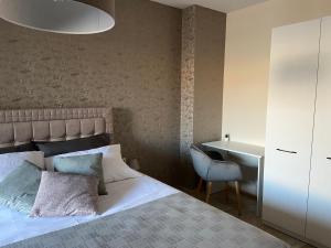 a bedroom with a bed and a desk and a table at Beach Residence Pomorie in Pomorie