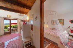 a bedroom with a bed and a balcony at coda cavallo villaggio cala paradiso villino C4 in San Teodoro