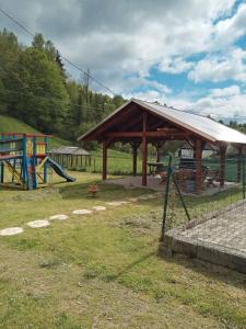 a playground with a wooden pavilion and a play area at Apartmány Božka in Terchová