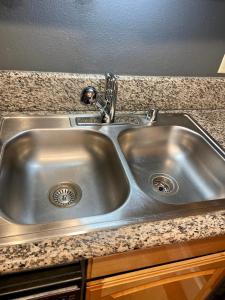 a stainless steel kitchen sink in a kitchen at Desert Getaway in Desert Hot Springs