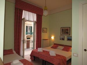 Postel nebo postele na pokoji v ubytování Hotel Massimo