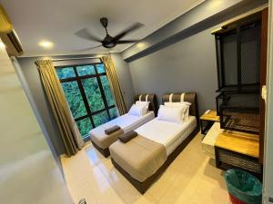 a bedroom with two beds and a window at EagleNest at Marina Cove Resort in Lumut +11 photos