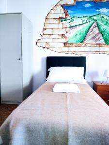 A bed or beds in a room at Affittacamere di Andrea Bertolino Anzola dell'Emilia
