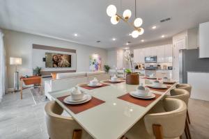 a dining room and living room with a table and chairs at Formosa Valley by UNE Homes in Orlando