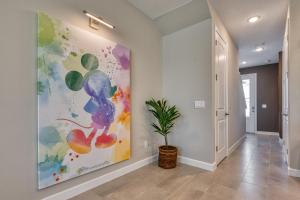 a hallway with a painting on the wall and a plant at Formosa Valley by UNE Homes in Orlando