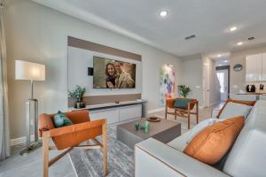 a living room with a couch and a tv at Formosa Valley by UNE Homes in Orlando