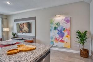 a kitchen with a counter and a painting on the wall at Formosa Valley by UNE Homes in Orlando