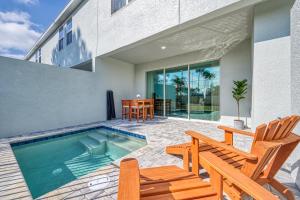 a house with a swimming pool and two chairs at Formosa Valley by UNE Homes in Orlando