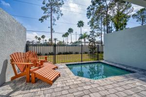 a patio with two chairs and a swimming pool at Formosa Valley by UNE Homes in Orlando