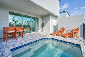 a house with a pool and a table and chairs at Formosa Valley by UNE Homes in Orlando