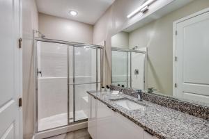 a bathroom with two sinks and a shower at Formosa Valley by UNE Homes in Orlando