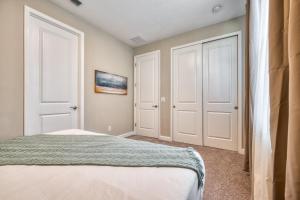 a bedroom with two white doors and a bed at Formosa Valley by UNE Homes in Orlando