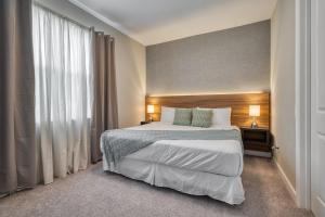 a hotel room with a bed and a window at Formosa Valley by UNE Homes in Orlando