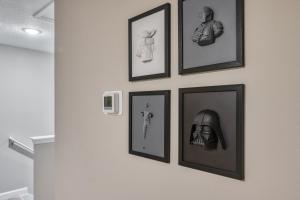 a group of framed pictures hanging on a wall at Formosa Valley by UNE Homes in Orlando