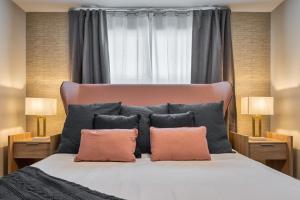 a bedroom with a large bed with two pillows at Formosa Valley by UNE Homes in Orlando