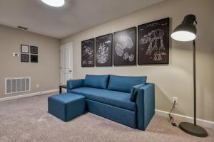 a living room with a blue couch and a lamp at Formosa Valley by UNE Homes in Orlando