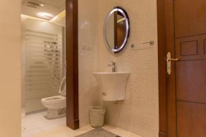 a bathroom with a sink and a toilet at Mostar Resort in Riyadh