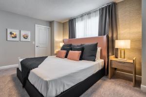 a bedroom with a bed with pillows and a window at Formosa Valley by UNE Homes in Orlando