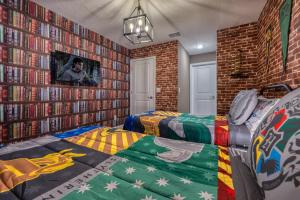 a bedroom with two beds and a wall of books at Formosa Valley by UNE Homes in Orlando