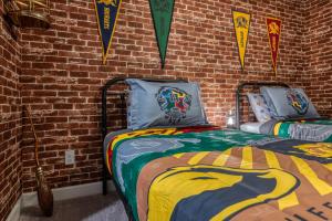 a bedroom with a bed with a brick wall at Formosa Valley by UNE Homes in Orlando