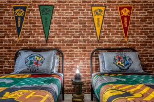 two beds in a room with kites on a brick wall at Formosa Valley by UNE Homes in Orlando