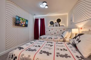 a bedroom with two beds in a room with a bedspread with animals at Formosa Valley by UNE Homes in Orlando