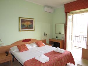 Postel nebo postele na pokoji v ubytování Hotel Massimo