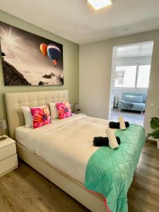 a bedroom with a large bed with colorful pillows at Sea Dreams with Amazing Terrace in Sitges
