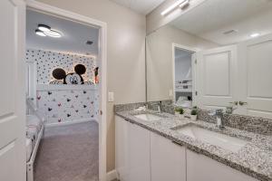 a bathroom with two sinks and a mirror at Formosa Valley by UNE Homes in Orlando