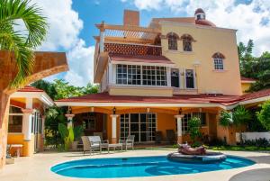 a house with a swimming pool in front of it at VILLA RODA Luxury & Art in Cancún