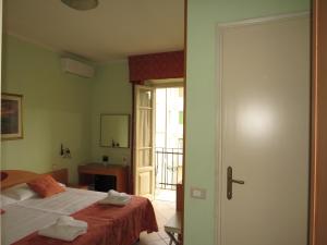 Postel nebo postele na pokoji v ubytování Hotel Massimo