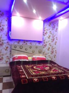 a bedroom with a bed with avertisement at شقة فندقية اسكندر ابراهيم in Alexandria