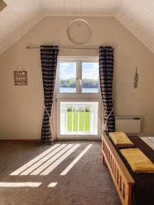 a bedroom with a bed and a window at Medway Lodge in South Cerney
