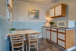 a kitchen with a table and a microwave at The Heights Hotel in Falmouth