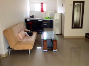 a cat laying on a couch in a kitchen at Silver Sands in Flic-en-Flac