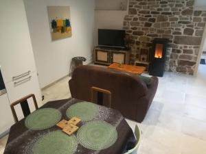 a living room with a couch and a table at Cap sur le Viaduc in Sibiril