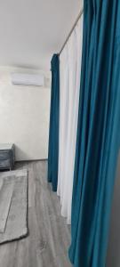 a row of blue and white curtains in a room at Apartament AlyMit Băile Herculane in Băile Herculane
