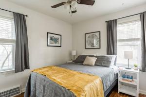 a bedroom with a bed and a ceiling fan at Pet Friendly - Large Families - Heart of Royal Oak - 5 Smart TVs in Royal Oak