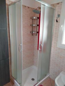 a shower with a glass door in a bathroom at CASA VACANZA NEL GIARDINO DELLE VIGNE in Chiaramonte Gulfi