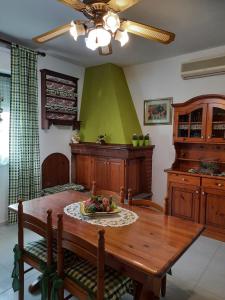 a kitchen with a wooden table with a plate of fruit on it at Appartamento Domusnovas in Domusnovas