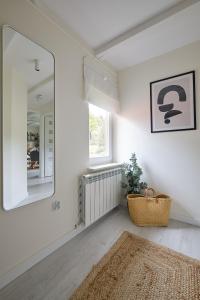 a white room with a mirror and a rug at Przytulny apartament SUDECKI KLIMAT by SpaceApart in Szklarska Poręba