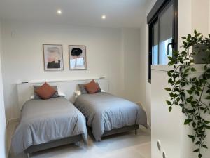 two beds sitting next to each other in a room at Hacienda Miraflores in Córdoba