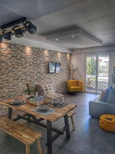 a living room with a table and a brick wall at Cannes Holiday suite à 2 pas du festival in Cannes