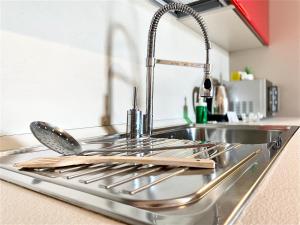 a kitchen sink with a bunch of utensils on it at 15 minuti dall'Istituto Ortopedico Galeazzi - Appartamento Silenzioso con Cucina, WiFi e Netflix in Milan