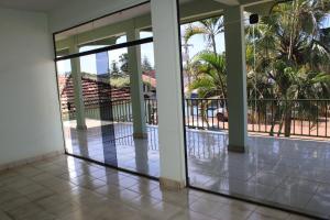 an empty lobby with glass doors and palm trees at Artidoros Hotel in Pedro Gomes