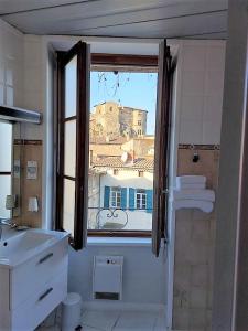 a bathroom with a window with a view of a building at Le Château in Tournon-sur-Rhône